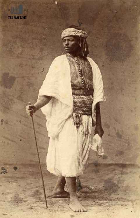 The Amshaji in his distinctive attire and cane in 1860